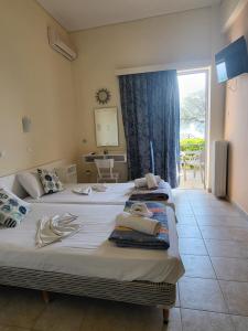 a bedroom with two beds with towels on them at ASTIR COSY LIVING HOTEL in Agios Konstantinos
