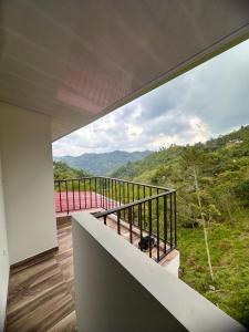 a room with a balcony with a view of the mountains at Finca los Tres Ángeles in Vergara