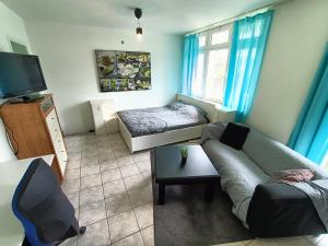 a living room with a couch and a bed at Three bedroom apartment in Heerlen in Heerlen
