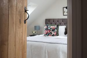 a bedroom with a bed with a pillow on it at Mill Cottage, Brockmill Farm in Berwick-Upon-Tweed