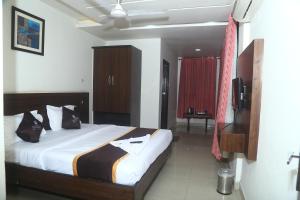 a bedroom with a bed and a television in it at Park Niveda in Shamshabad