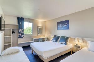 Postel nebo postele na pokoji v ubytování Ace Hotel Riom