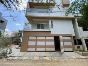 a house with two garage doors in front of it at SSN Home Stays in Bangalore near PLAY Arena in Bangalore