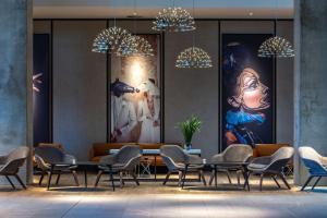 a dining room with chairs and a table and chandeliers at Radisson Blu Hotel Frankfurt in Frankfurt