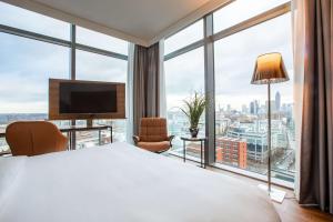 a hotel room with a large bed and a large window at Radisson Blu Hotel Frankfurt in Frankfurt +57 photos