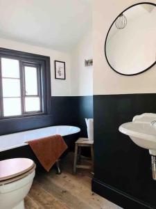 a bathroom with a tub and a toilet and a sink at Luxury City Centre Townhouse - Sleeps 6 in Chester