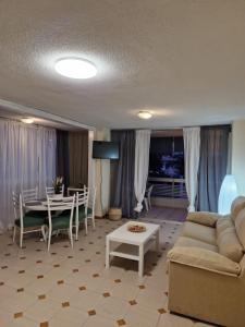 a living room with a couch and a table at Costa Blanca apartment in Alicante