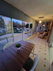 a wooden table and chairs on a balcony at Costa Blanca apartment in Alicante