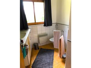a bathroom with a sink and a toilet and a window at Beautiful holiday home near town centre in Reisach
