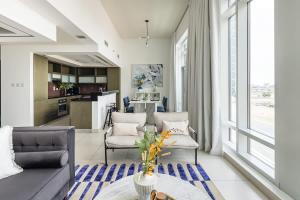 a living room with a couch and a table at Frank Porter - The Lofts Central in Dubai