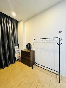 a room with a bed and a black curtain at ITCC Manhattan Suites by AURORA in Penampang
