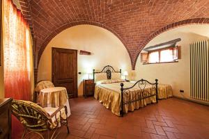 a bedroom with two beds and a brick wall at Fonte Del Castagno in Sinalunga +148 photos