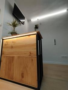 a wooden door in a room with a speaker at Onefam Madrid in Madrid