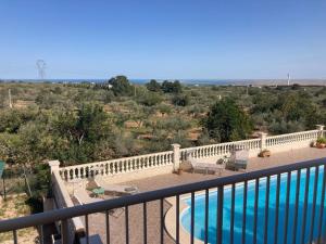 a balcony with a view of a swimming pool at El Milagro in L'Ampolla