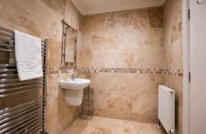 a bathroom with a sink and a toilet in it at Stones Throw in Scarborough