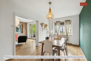 a dining room and living room with a table and chairs at 15-Min to Zurich Center: Cozy Apartment in Zurich