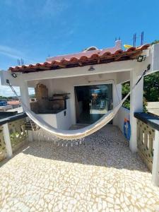 a house with a hammock on the outside of it at Studio com varanda - Melhor localização do Arruda in Recife