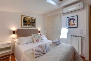a bedroom with a bed with towels on it at Poggio Imperiale Apartment by Mamo Florence in Florence