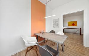 a dining room with a table and white chairs at Beautiful Apartment In Eilenburg in Eilenburg