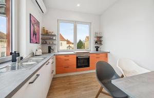 a kitchen with orange cabinets and a window at Beautiful Apartment In Eilenburg in Eilenburg