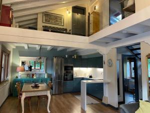 a kitchen with blue cabinets and a table in a kitchen at Casa rural en Fontibre in Espinilla