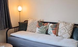 a couch with pillows on it in a room at Luxury Family Apartment- Close to Leicester University in Leicester +6 photos