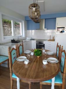 a kitchen with a wooden dining table and chairs at Vacacional muelle alto A Guarda in A Guarda