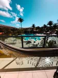 a view of a swimming pool with palm trees at Hotel Beach Hills in Porto Seguro