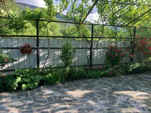 a white fence with flowers in a garden at borjomi wood edge in Borjomi