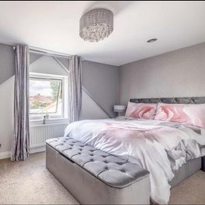 a bedroom with a large bed and a window at Large Bungalow to sleep up to 8 in Slough