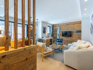 two pictures of a living room with a couch and chairs at Appartement Val-d'Isère, 3 pièces, 4 personnes - FR-1-694-331 in Val-d'Isère