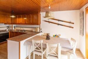 a kitchen with a table and chairs in a kitchen at Dúplex Carlina in Saga 