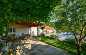 a house with a patio and a swimming pool at Stunning Home In Ruda With House A Panoramic View in Ruda