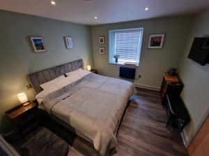 a bedroom with a large bed and a window at Harlech House in Harlech
