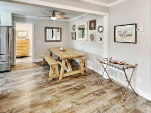 a dining room with a table and a refrigerator at Boho Beach House in Tybee Island