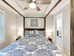 a bedroom with a large bed with a ceiling fan at Boho Beach House in Tybee Island