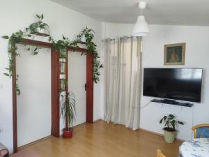a living room with a flat screen tv on a wall at Kuća za odmor TRI SUNCA in Pula