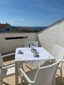 a white table and chairs on a balcony at Villa Lory Krk in Krk