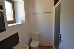 een badkamer met een toilet, een raam en een spiegel bij Skyfall Maison in Valcebollère