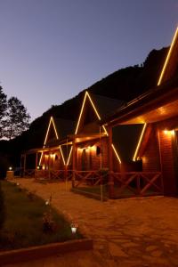 a cabin with lights on the side of it at night at KOZLUCA Bungalov in Trabzon