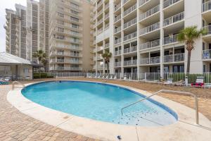 a swimming pool in front of a large apartment building at Windward Pointe 706 in Orange Beach