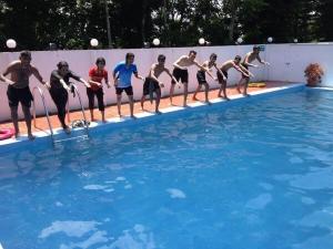 a group of people standing in a swimming pool at Excelsior Sylhet Hotel & Resort in Sylhet