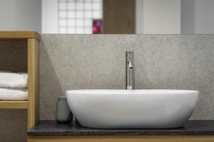 a white sink with a faucet on a counter at Nikolausberg - Hof im Garten in Caldaro +23 photos