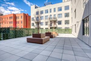 a courtyard with a tree in the middle of a building at Dumbo 2br w wd roof gym nr TimeOut Building NYC-957 in Brooklyn