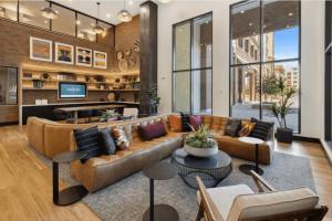 a living room with a couch and a table at Blueground Hayward pool outdoor kitchens SFO-1695 in Hayward