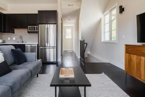 a kitchen and living room with a couch and a table at Blueground Burlingame wd ac near Caltrain SFO-1687 in Burlingame