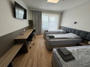 A television and/or entertainment centre at F Hotel 24h Check-In