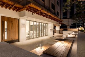 a lobby of a building with tables and benches at Sunbee Hotel Insadong Seoul in Seoul