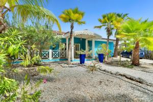 a house with palm trees in front of it at Starshipvillas Bonaire in Kralendijk