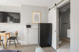 a living room with a black dresser and a table at Beacon Hill studio nr boston common shops BOS-906 in Boston